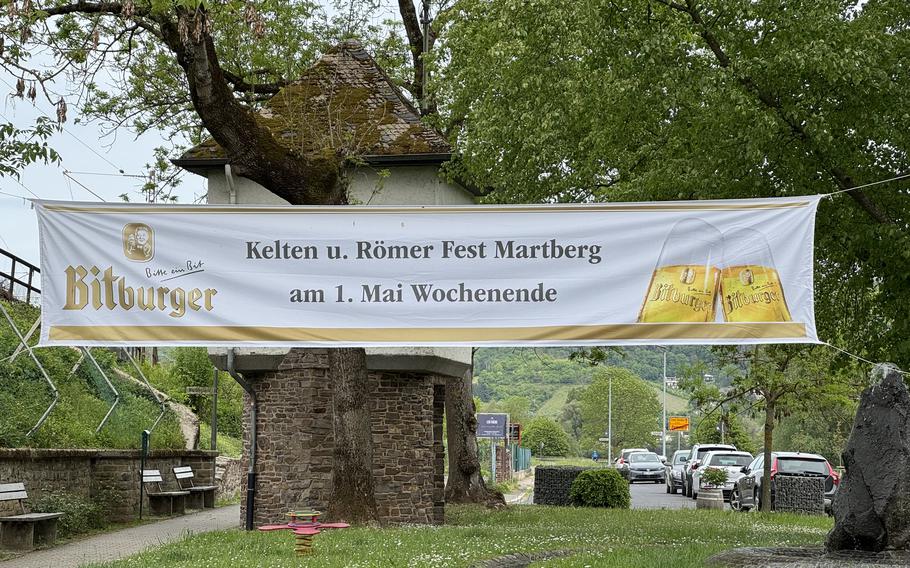 Sign in front of a tree which translates to “Celtic and Roman Fest Martburg | First Weekend of May”